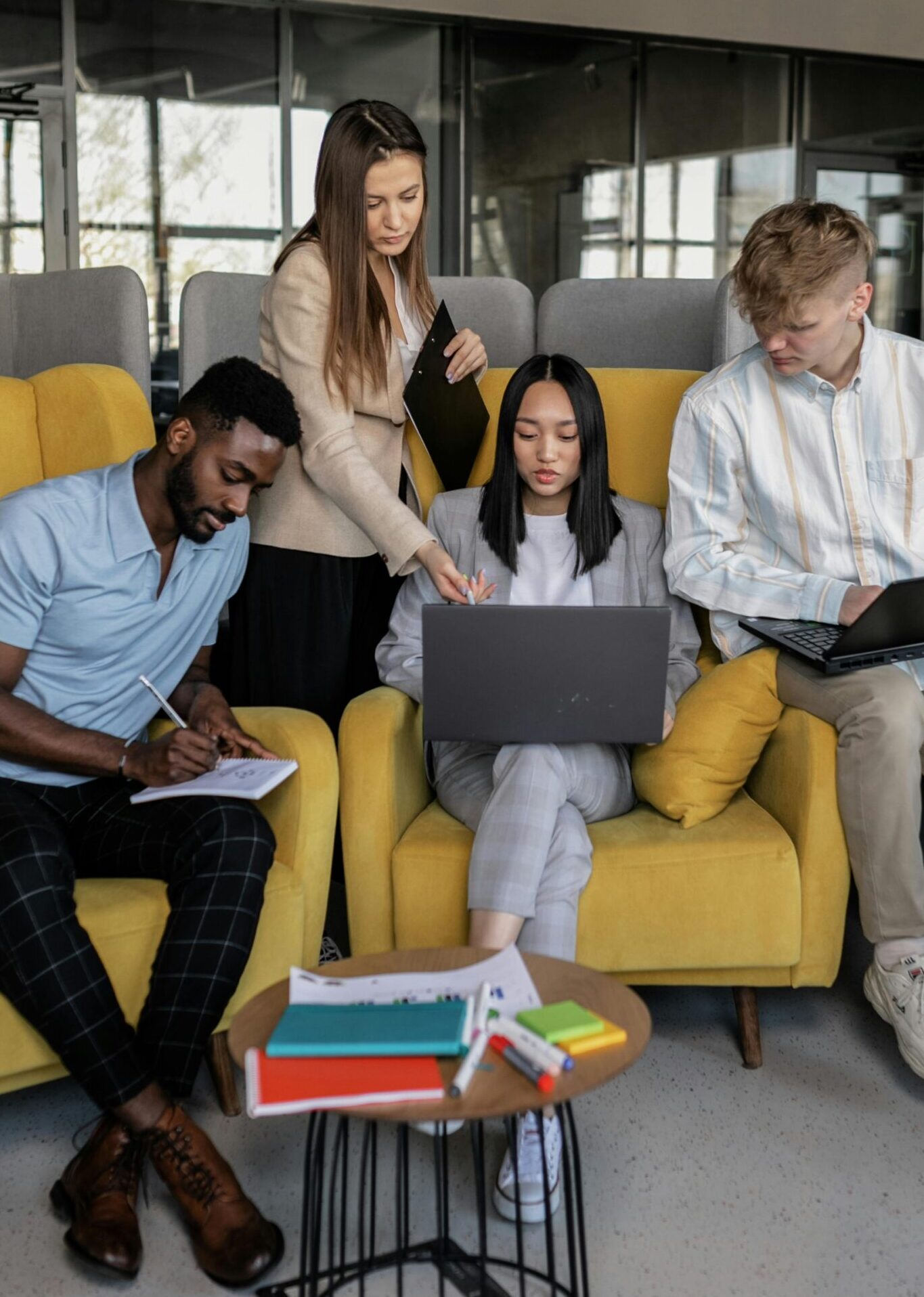 A diverse group of coworkers engaged in a collaborative meeting in a modern office space.